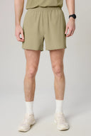 Men's clay beige athletic shorts with elastic waistband, styled for activewear