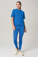 Woman wearing cobalt blue loose fit activewear t-shirt and matching blue leggings