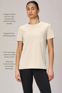 Woman wearing sand-colored collagen-infused performance tee with moisture-wicking technology