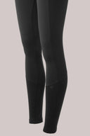 Charcoal compression leggings with mesh panels, close-up on lower legs, athleisure wear