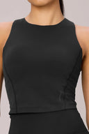 Woman wearing charcoal compression sports bra with high neckline, seamless activewear design