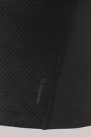 Close-up of a charcoal mesh compression sports bra with textured and smooth fabric panels