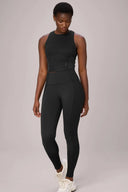 Woman wearing charcoal mesh compression sports bra and matching high-waist leggings