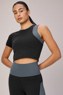 Woman wearing charcoal granite performance crop tee and colorblock high-waist leggings