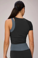Back view of woman wearing charcoal and granite performance tee and high-waisted leggings