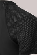 Close-up of black athletic tee with breathable mesh shoulder panel and flatlock seams