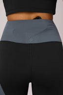High-waisted color-blocked cropped leggings in charcoal and granite with hidden waistband pocket