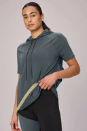Woman wearing short sleeve granite pima hoodie and colorblock leggings, athleisure style