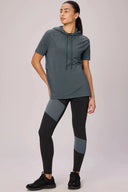 Woman in short sleeve pima hoodie and colorblock leggings, athleisure apparel