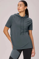 Woman wearing granite short-sleeve pima cotton hoodie and colorblock leggings