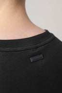 Close-up of charcoal crewneck t-shirt back with Seissense label, soft fabric texture