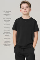 Boy wearing charcoal basic tee and matching joggers, featuring moisture-wicking and UV protection.