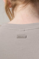 Close-up of girl wearing driftwood beige basic tee with back neck Seissense label