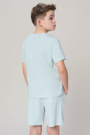 Boy wearing light blue short-sleeve activewear t-shirt and shorts set, back view