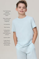 Boy wearing light blue basic athletic tee and shorts, featuring comfort and performance benefits