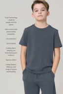 Boy wearing granite grey basic tee and joggers, highlighting cooling and stretch fabric features.
