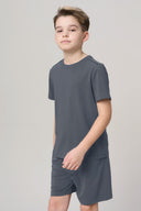 Boy wearing granite gray basic tee and shorts, minimalist athleisure style