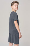 Boy in granite gray short sleeve activewear tee and matching shorts, side view