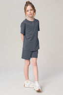 Girl wearing granite grey short sleeve tee and shorts athleisure set, neutral background