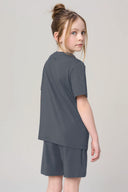 Girl wearing granite gray basic tee and shorts set, viewed from back, athleisure apparel