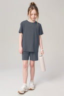 Girl in granite grey basic tee and shorts set, holding water bottle, athleisure apparel
