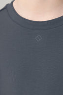 Close-up of a granite gray crew neck tee with small chest logo, soft fabric texture