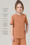 Girl in mocha short-sleeve athleisure tee and shorts with performance features listed beside.