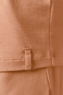 Close-up of mocha brown boys’ basic tee shirt hem with visible stitching and fabric tag