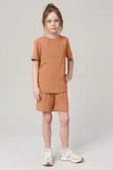Girl wearing mocha brown basic tee and matching shorts, casual athleisure outfit