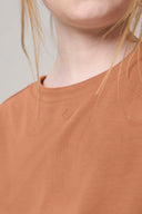 Close-up of mocha brown crewneck tee on woman, athleisure activewear detail