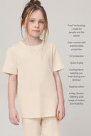 Girl wearing sand-colored basic tee and shorts, showcasing soft, comfortable athleisure.