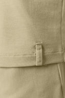 Close-up of beige ribbed athleisure fabric with stitched hem and Seissense tag