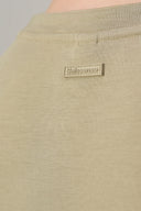 Close-up of light beige girls' basic tee shirt back neck detail with visible label