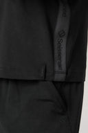 Closeup of charcoal boys' hooded tee with logo detail and pocket, soft athletic fabric