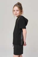Girl wearing charcoal hooded tee and shorts with logo trim, athleisure outfit studio shot