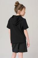 Girl wearing charcoal hooded short sleeve tee and shorts, back view, neutral background