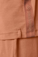 Closeup of mocha brown girls' hooded tee with textured side stripe and logo detail