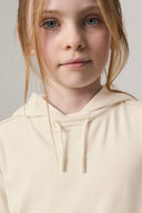Girl wearing a sand-colored hooded tee, close-up on face and upper garment