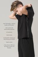 Boy wearing charcoal relaxed hoodie and shorts, showcasing PFAS-free athleisure.