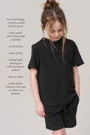 Girl wearing relaxed fit charcoal hoodie and shorts, showcasing kids athleisure apparel