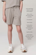 Girl wearing relaxed driftwood shorts with elastic waist, drawstring, and side pockets, promoting comfort and stretch.