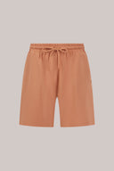 Mocha-colored relaxed fit shorts with drawstring waist and side pockets on plain background.