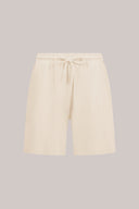 Sand-colored relaxed fit shorts with drawstring waist and side pockets, athleisure style