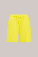 Bright yellow relaxed fit athletic shorts with drawstring waist and side pockets on plain background