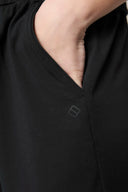 Close-up of hand in charcoal boys' athletic shorts pocket, soft fabric detail