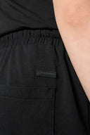 Close-up of charcoal athletic shorts with elastic waistband and rear pocket
