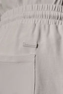 Close-up of light beige elastic waist shorts with pocket and Seissense label
