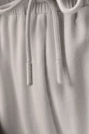 Closeup of light beige athleisure shorts with drawstring and elastic waistband