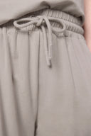 Close-up of beige girls' athleisure shorts with elastic waistband and drawstring tie