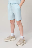 Boys' light blue athletic shorts with drawstring, side pockets, and neutral sneakers